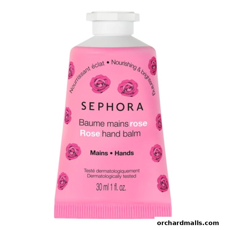 A pink tube of Sephora Rose hand balm with rose patterns and text.