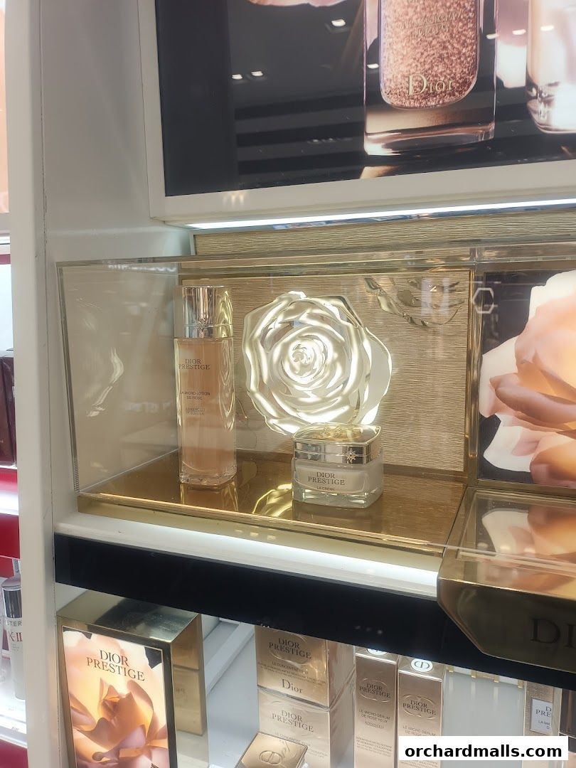 Dior Prestige skincare products displayed in a luxurious gold-themed setting.