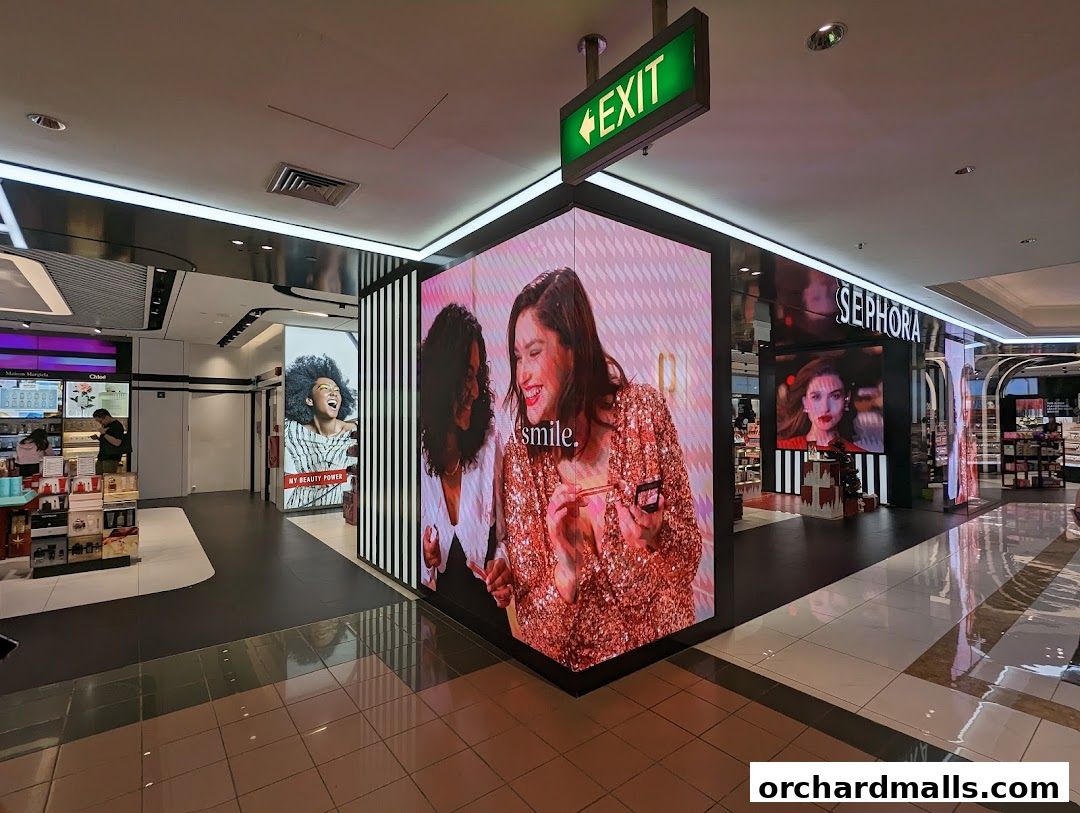 Sephora store interior with large digital displays showcasing beauty products and models.