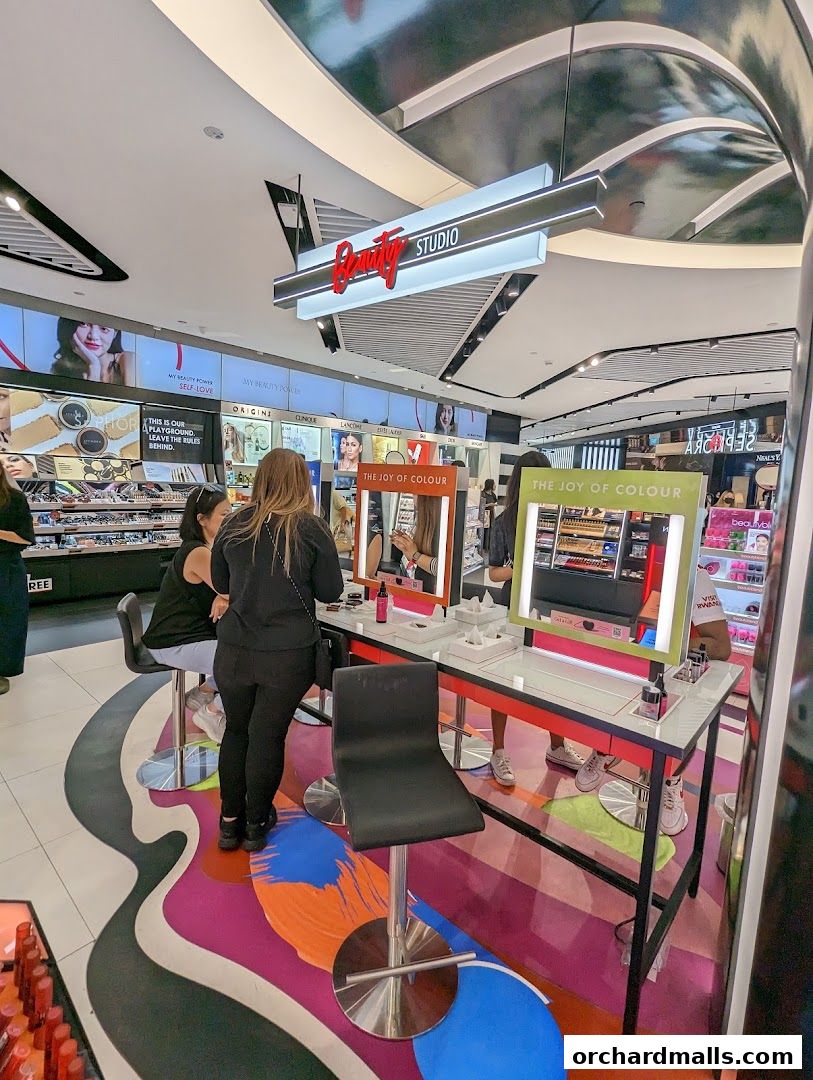 Interior of a Sephora beauty studio with makeup displays and customers.