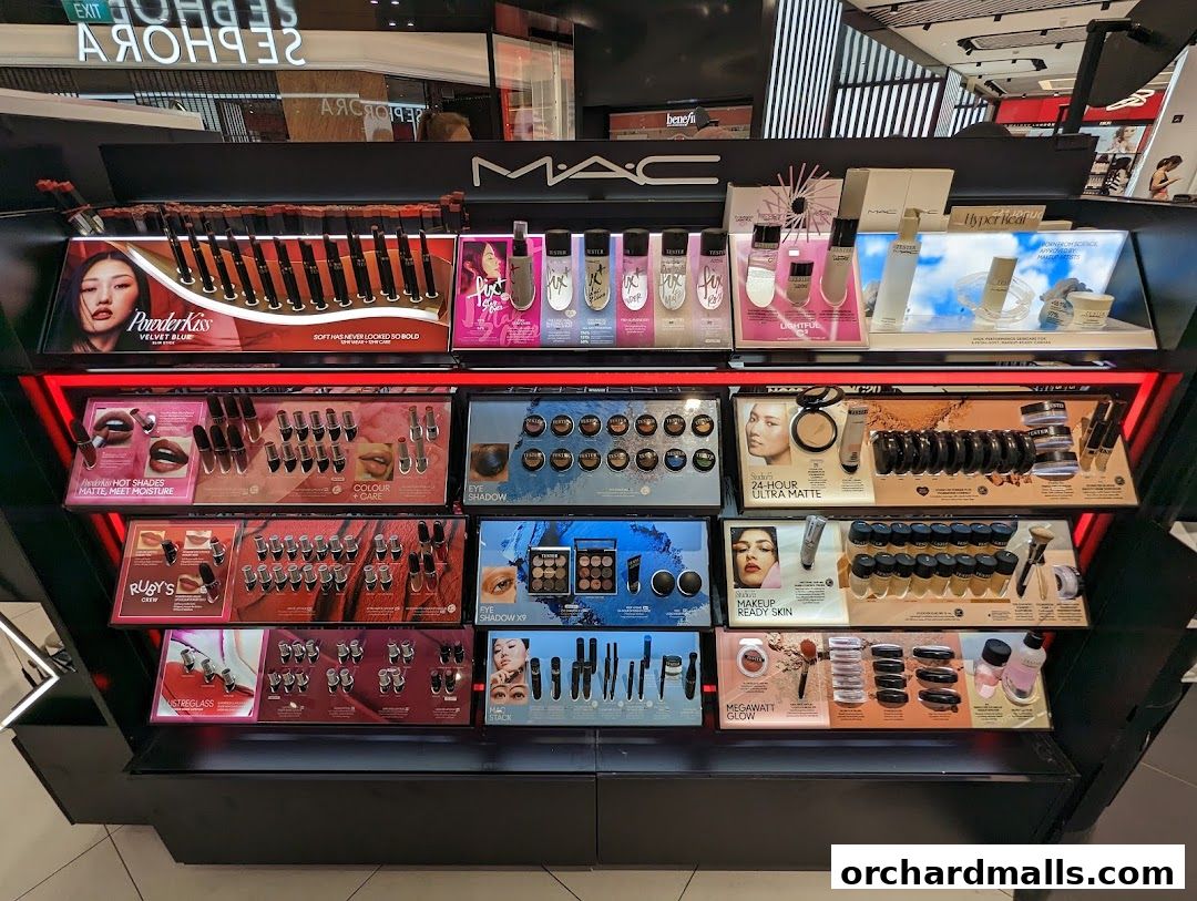 A display of MAC cosmetics including lipsticks, eyeshadows, and foundations.