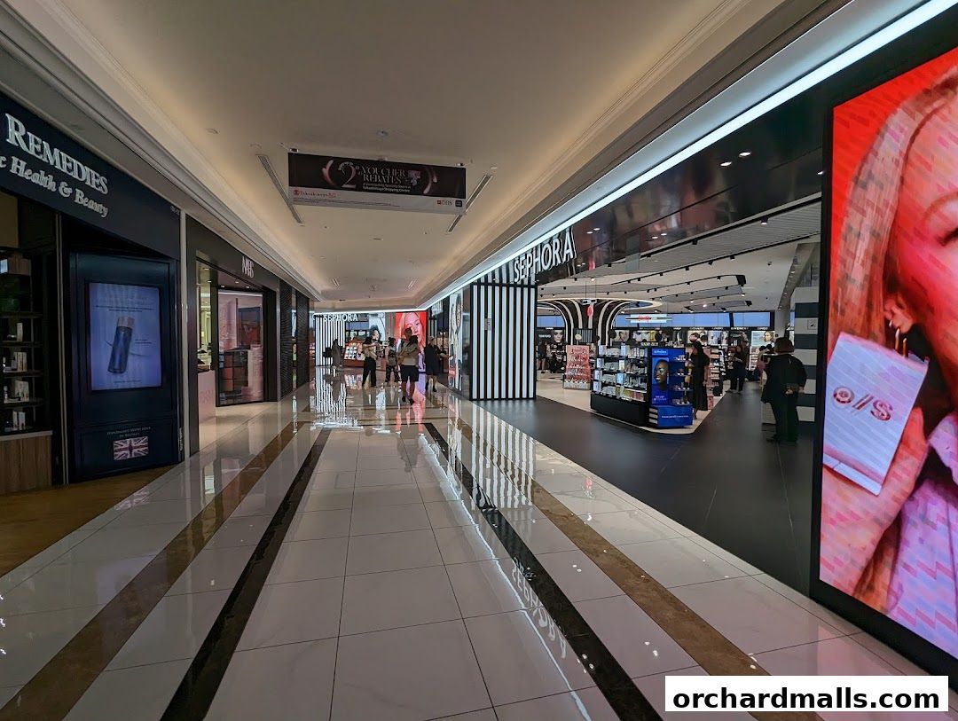 A well-lit shopping mall corridor with a Sephora store entrance and displays.