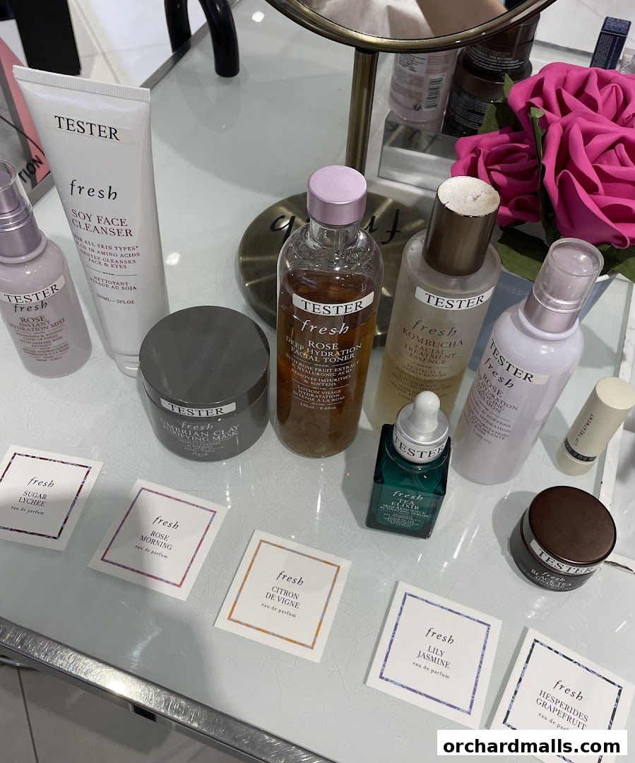 A collection of Fresh beauty products and fragrance samples displayed on a table.