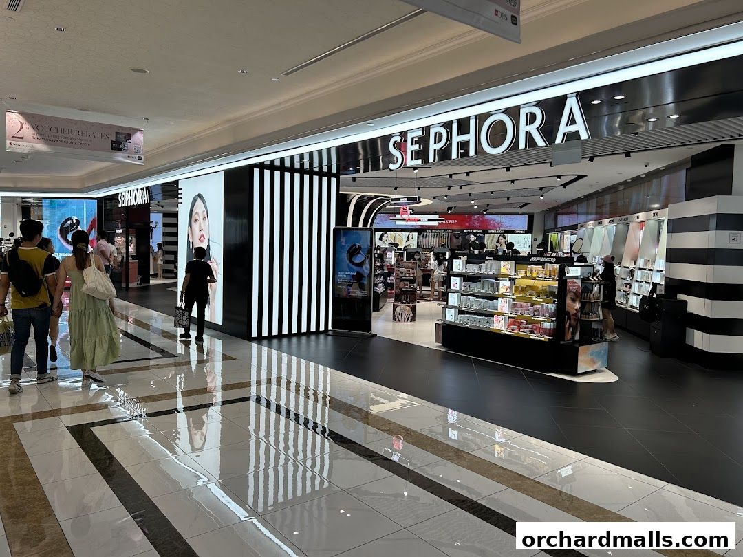 The entrance of a Sephora store in a shopping mall, showcasing beauty products.