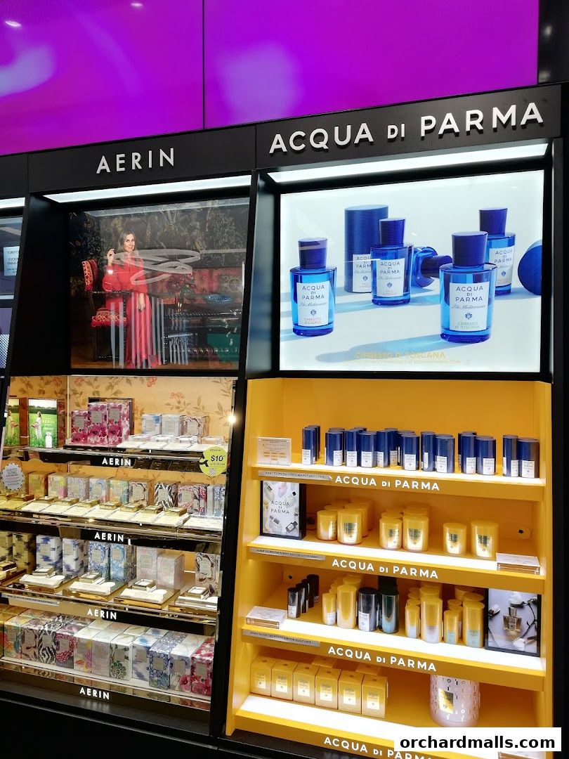 A display of luxury perfumes and beauty products from Aerin and Acqua di Parma.