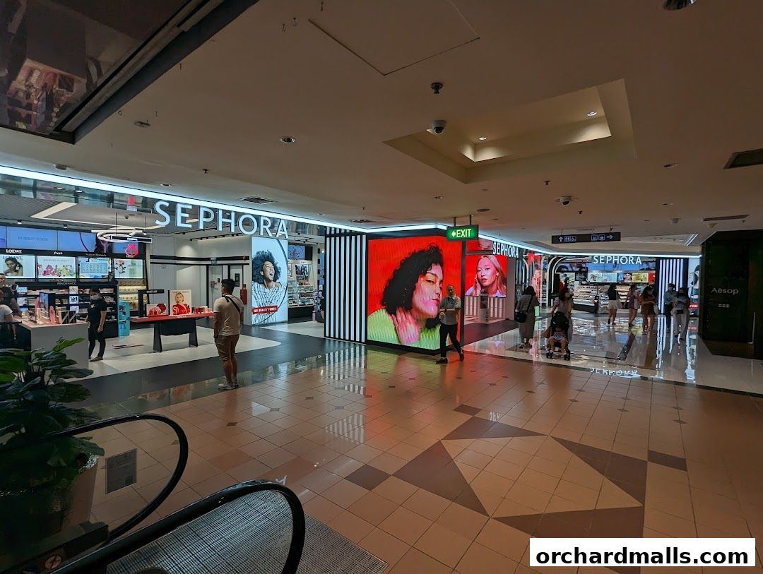 The entrance of a Sephora beauty store with large digital displays and product displays.