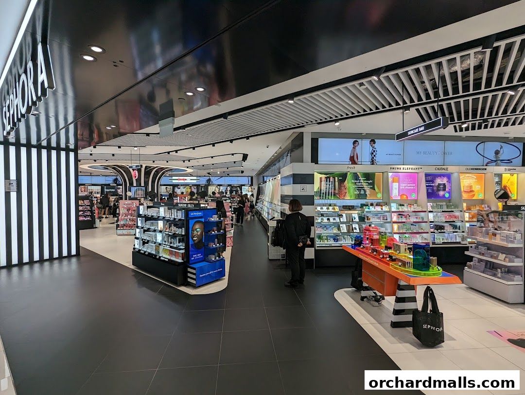 Interior view of a brightly lit Sephora store with various beauty products on display.