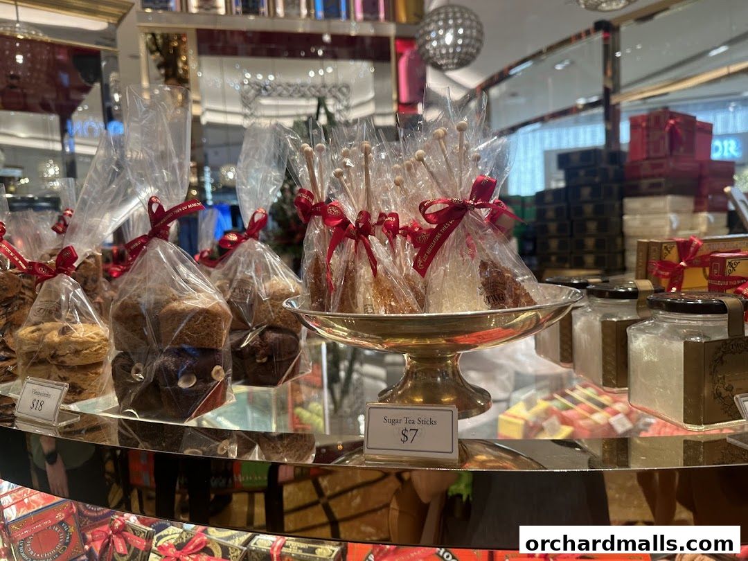A display of individually wrapped sugar tea sticks and pastries in a shop.