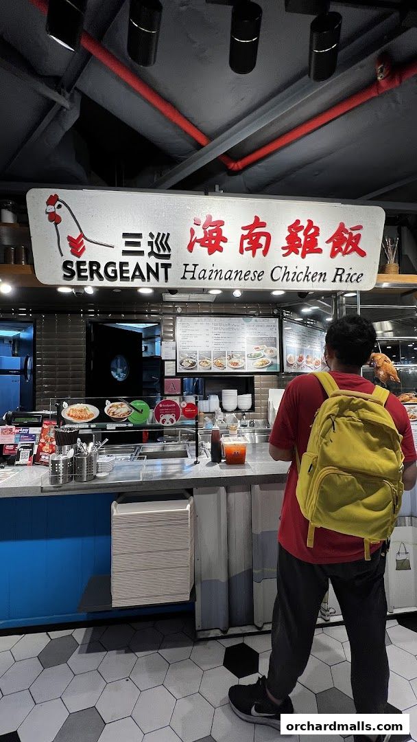A person stands at the counter of Sergeant Hainanese Chicken Rice, ordering food.