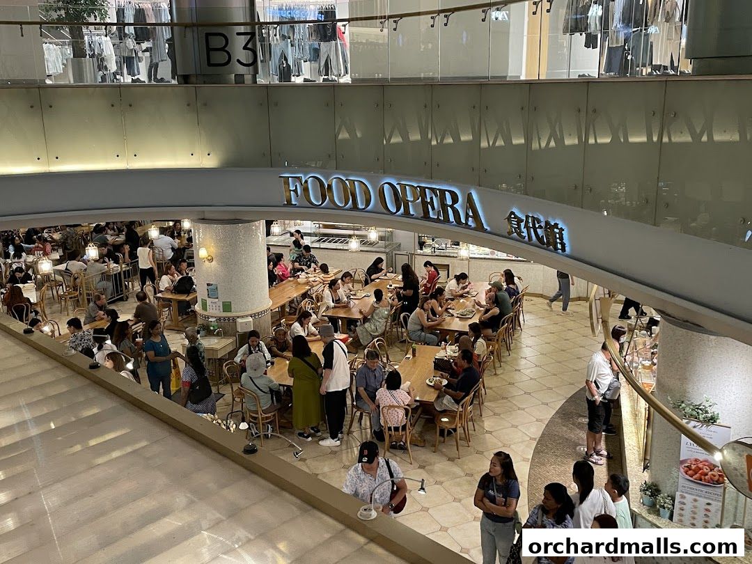 A busy food court with many people dining at tables under a sign that says FOOD OPERA.