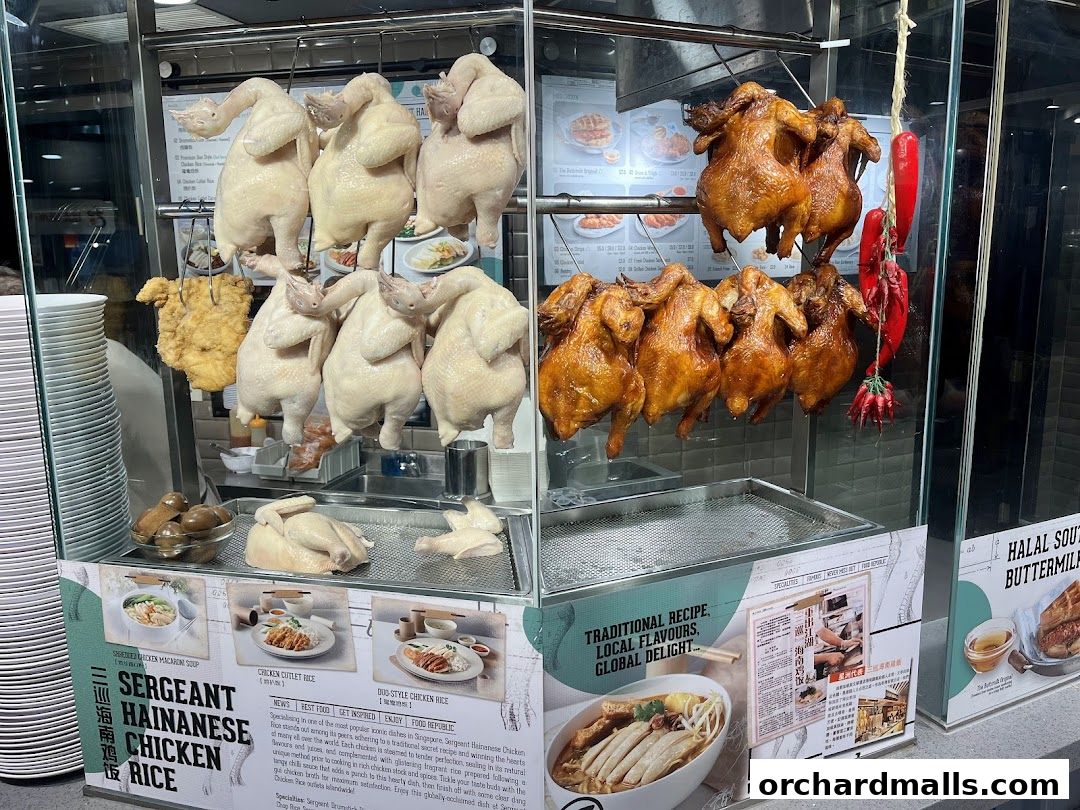 A display of raw and roasted chickens, with various chicken rice dishes advertised.