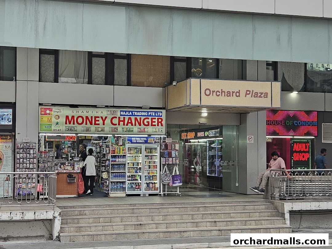 The exterior of Shamiha Money Changer shop with various products displayed.