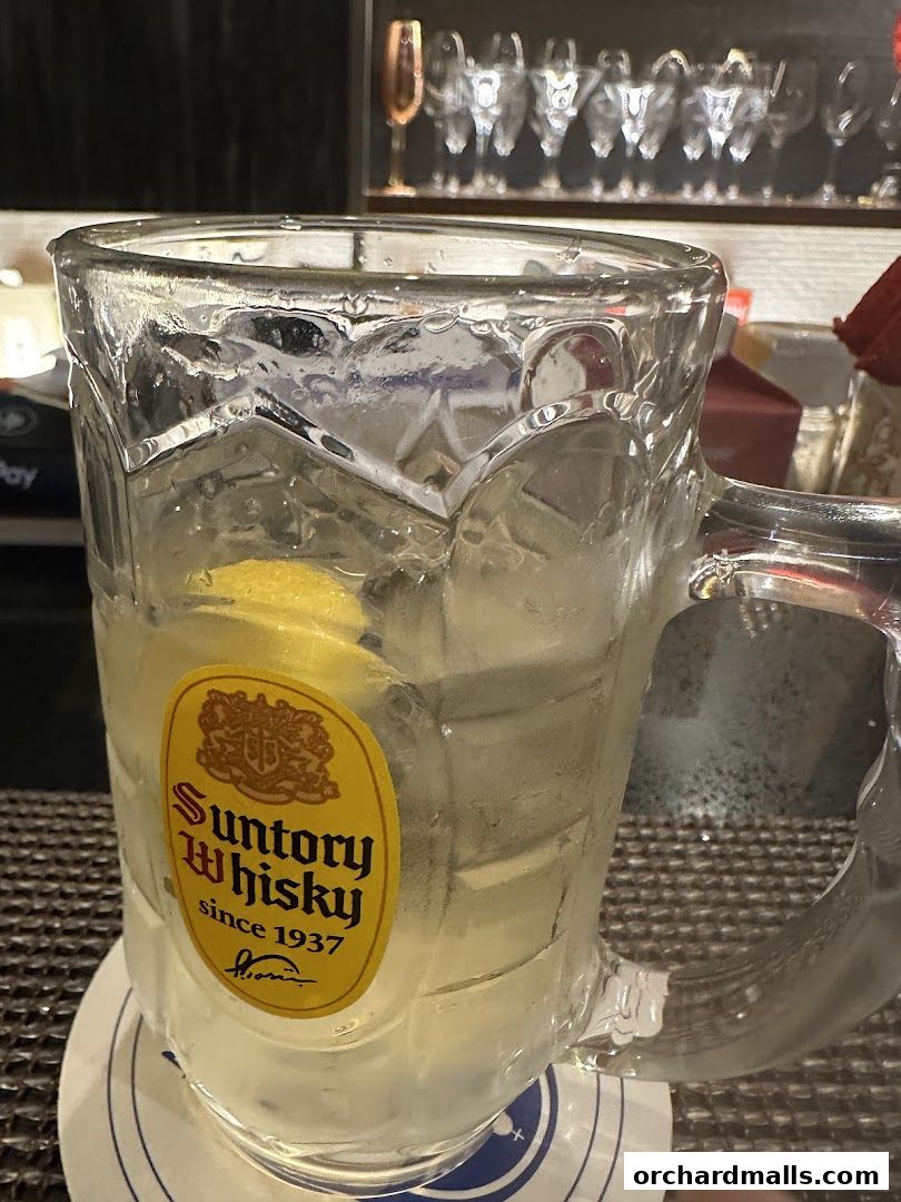 A refreshing glass of Suntory whisky with lemon and ice.