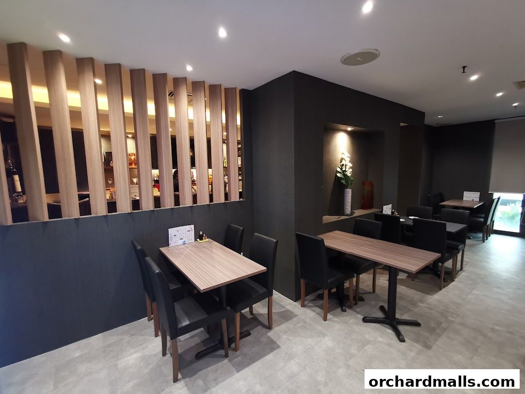 Interior view of ShinnSato Okinawa Cuisine restaurant with tables and chairs.