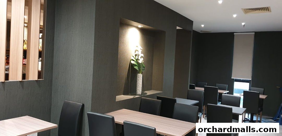 Interior of ShinnSato Okinawa Cuisine restaurant with tables and chairs.