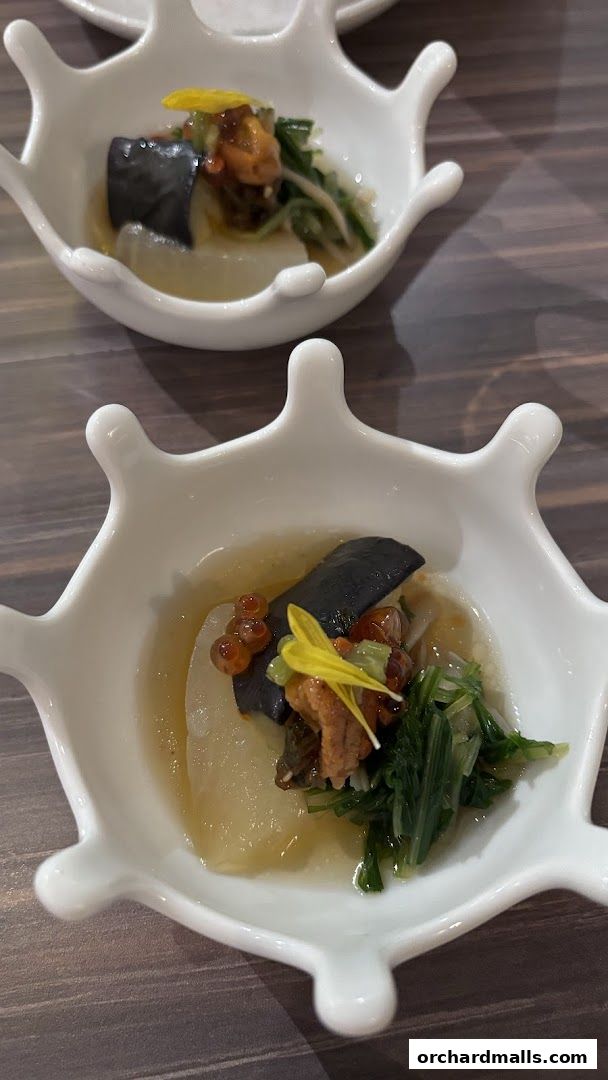 Two delicate servings of Okinawan cuisine in unique white bowls.