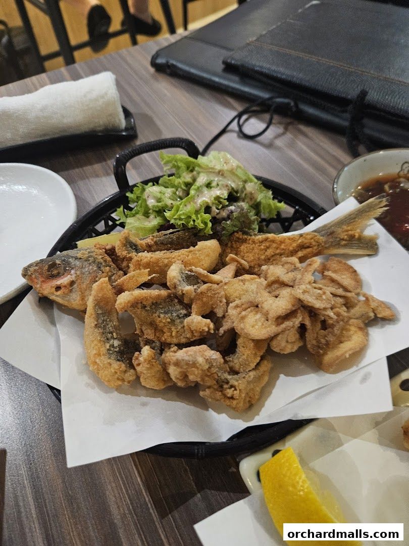 A basket of crispy fried fish and salad served at ShinnSato Okinawa Cuisine.