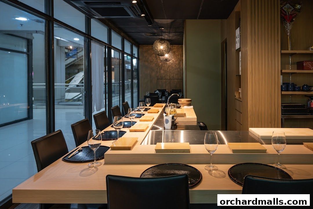 Elegant sushi bar with place settings and modern lighting.