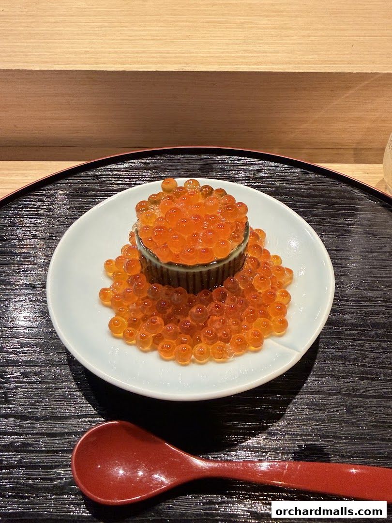 A close-up of a dish of ikura (salmon roe) served at Sushi Kyuu.