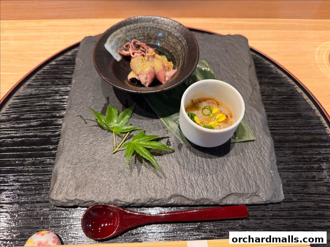 A beautifully presented Japanese appetizer with delicate seafood and a refreshing jelly dish.