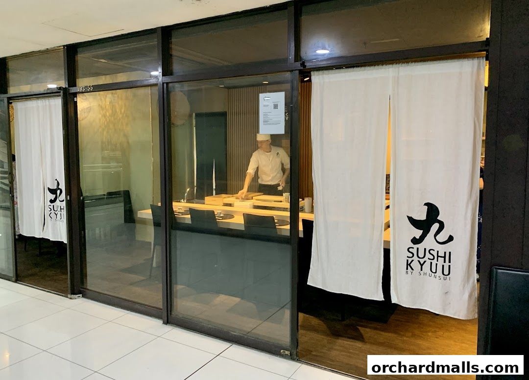 Entrance to Sushi Kyuu by Shunsui, featuring noren curtains and a chef visible inside.