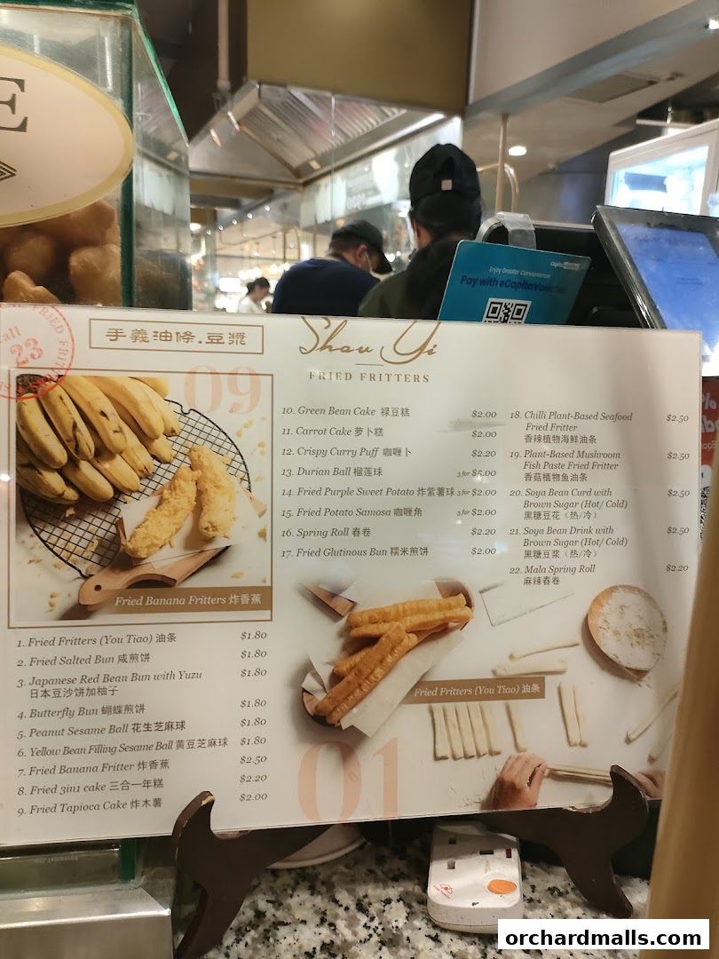 A menu for Shou Yi Fried Fritters, showcasing various fried snacks and drinks with prices.