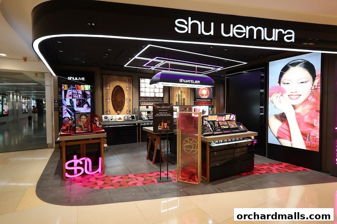 A well-lit Shu Uemura cosmetics store with makeup displays and a large advertisement.
