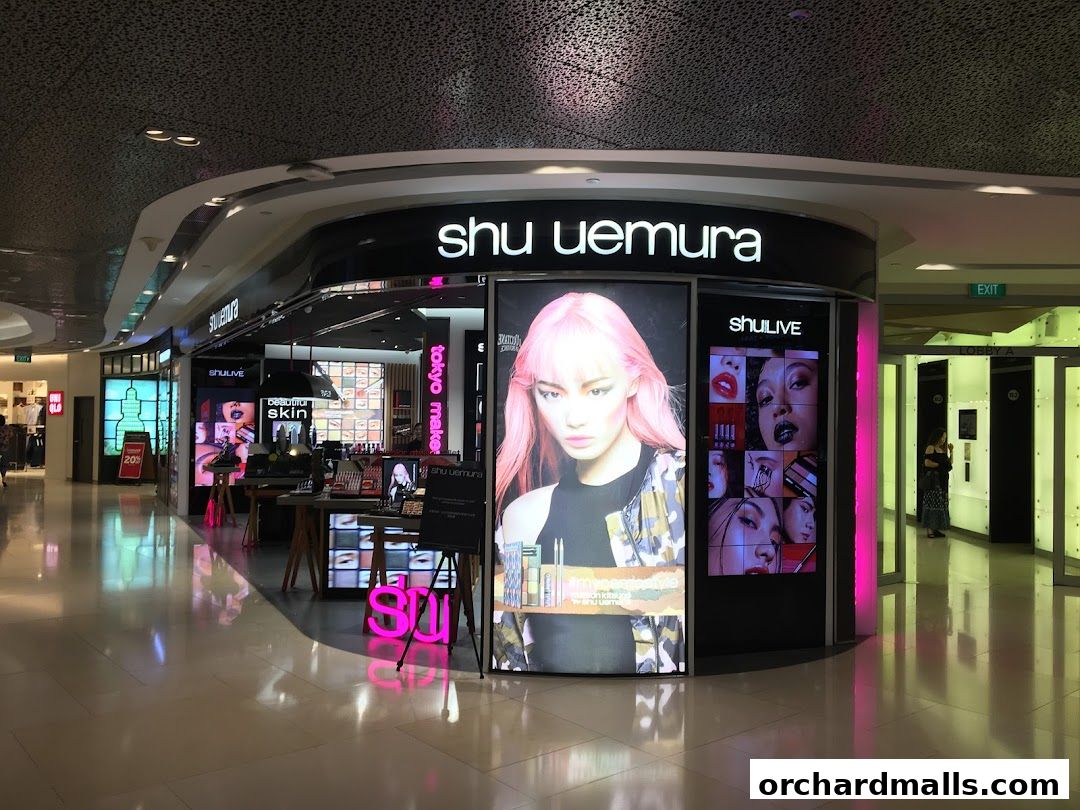 The Shu Uemura shop front features a large display with a model and makeup products.