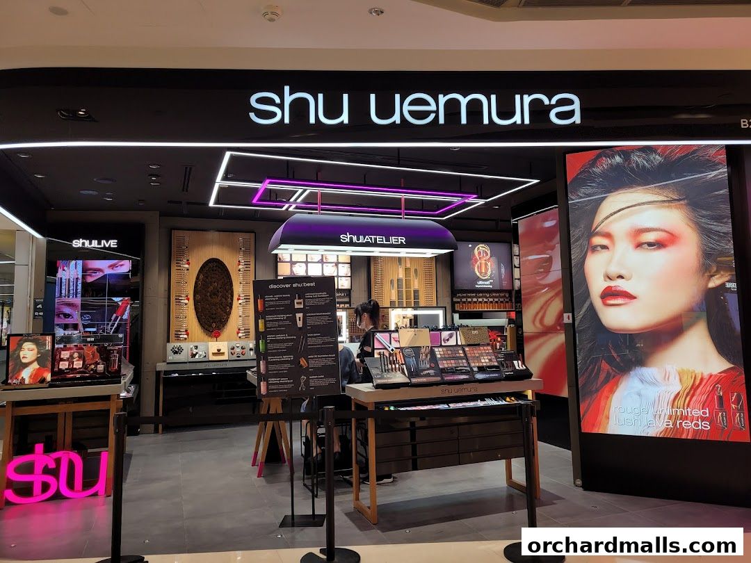 The Shu Uemura shop front displays makeup products and a large advertisement featuring a model.