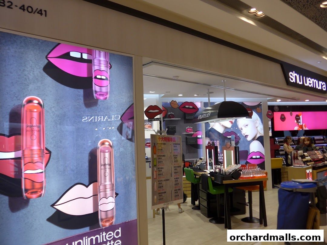 The Shu Uemura shop front features bold lip graphics and displays of lipstick products.