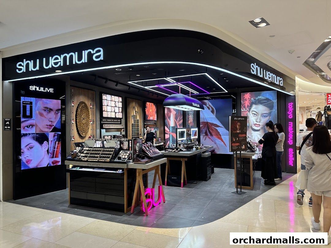 Shu Uemura makeup store interior with displays of products and digital screens.
