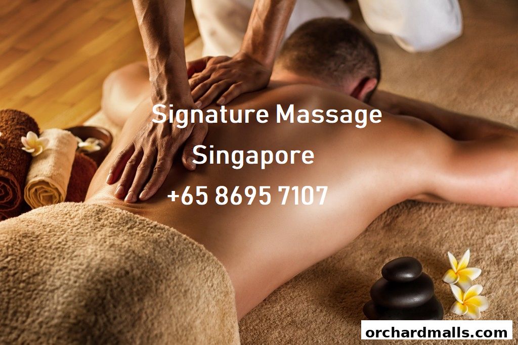 A person receiving a back massage with hot stones and flowers.