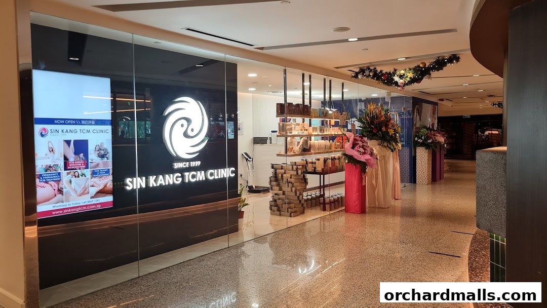 The exterior of Sin Kang TCM Clinic, showcasing its logo, services, and products.