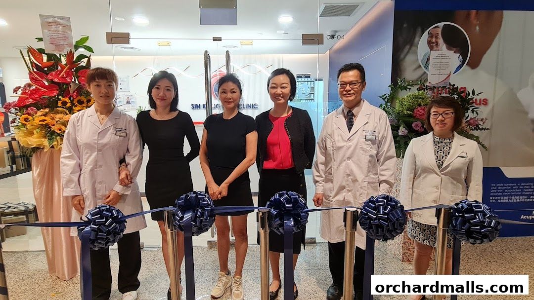 A team of professionals from Ma Kuang Holistic TCM Wheelock Place posing for a photo.