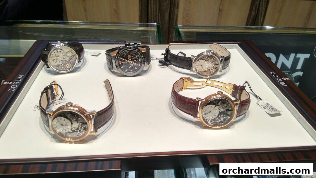 A display of luxury watches with intricate mechanical movements and leather straps.