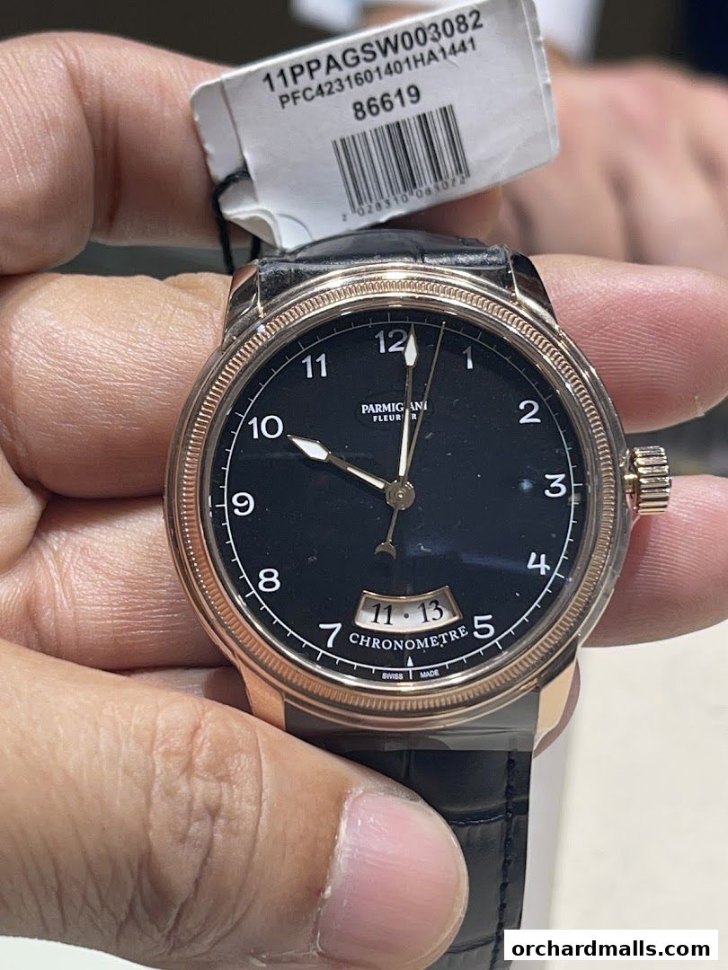 Close-up of a Parmigiani Fleurier chronometer watch with a black dial and rose gold case.