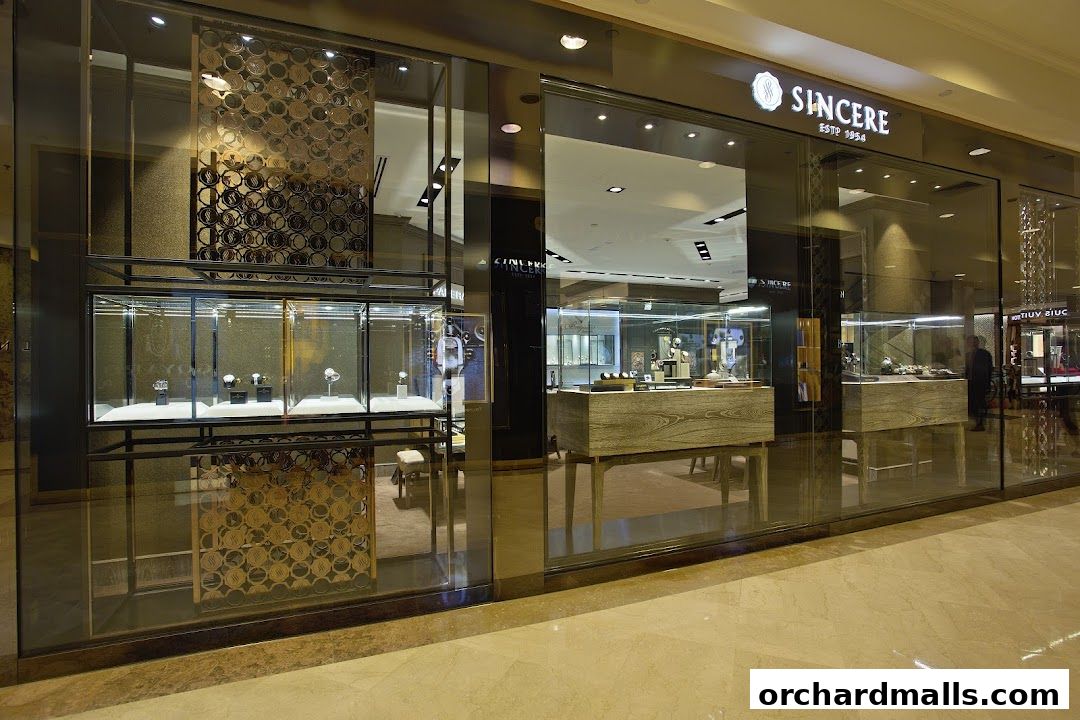 Exterior view of Sincere Fine Watches, showcasing elegant watch displays in illuminated glass cases.