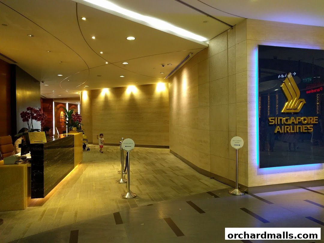 The Singapore Airlines Service Centre ION features a prominent logo and a reception desk.
