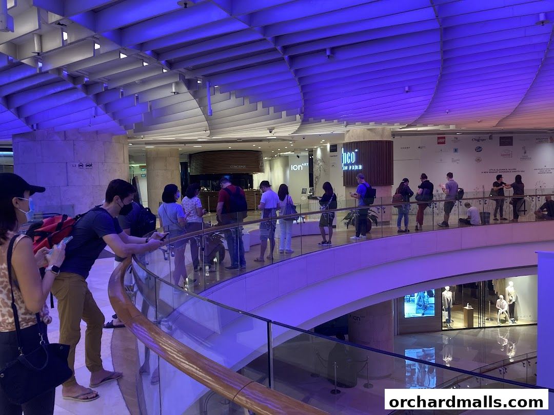 People queueing at the Singapore Airlines Service Centre ION in a modern mall.