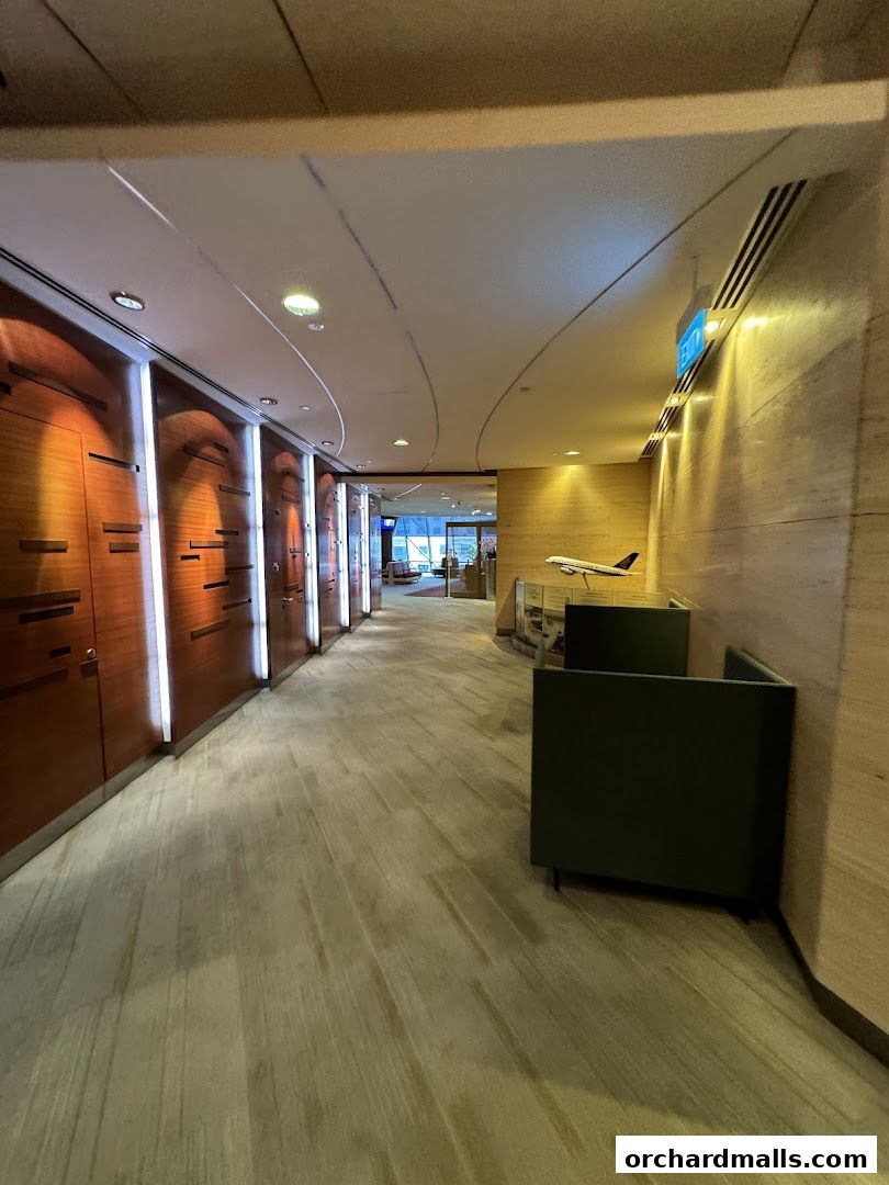 Interior hallway of Singapore Airlines Service Centre with wooden panels and an airplane model.