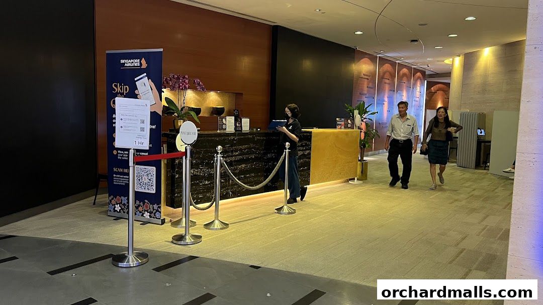Singapore Airlines Service Centre with staff at the counter and customers walking by.