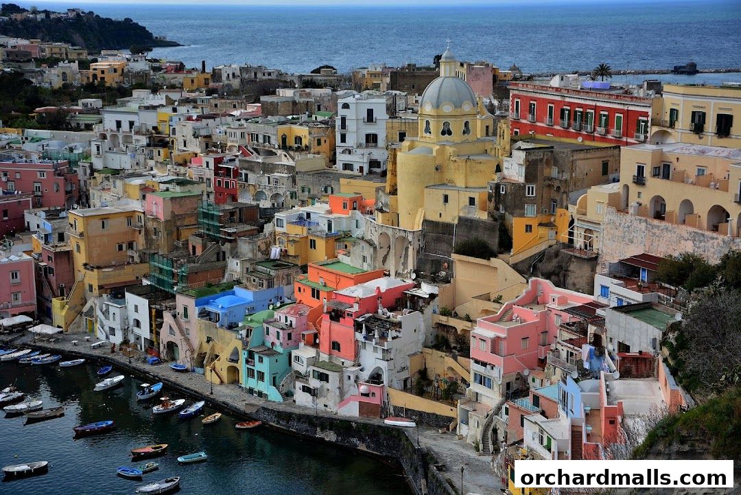 A picturesque coastal town with colorful buildings cascading down to a harbor filled with boats.