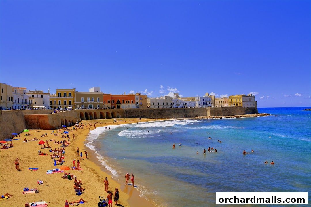 A vibrant beach scene with people sunbathing and swimming, set against a backdrop of historic Italian architecture.