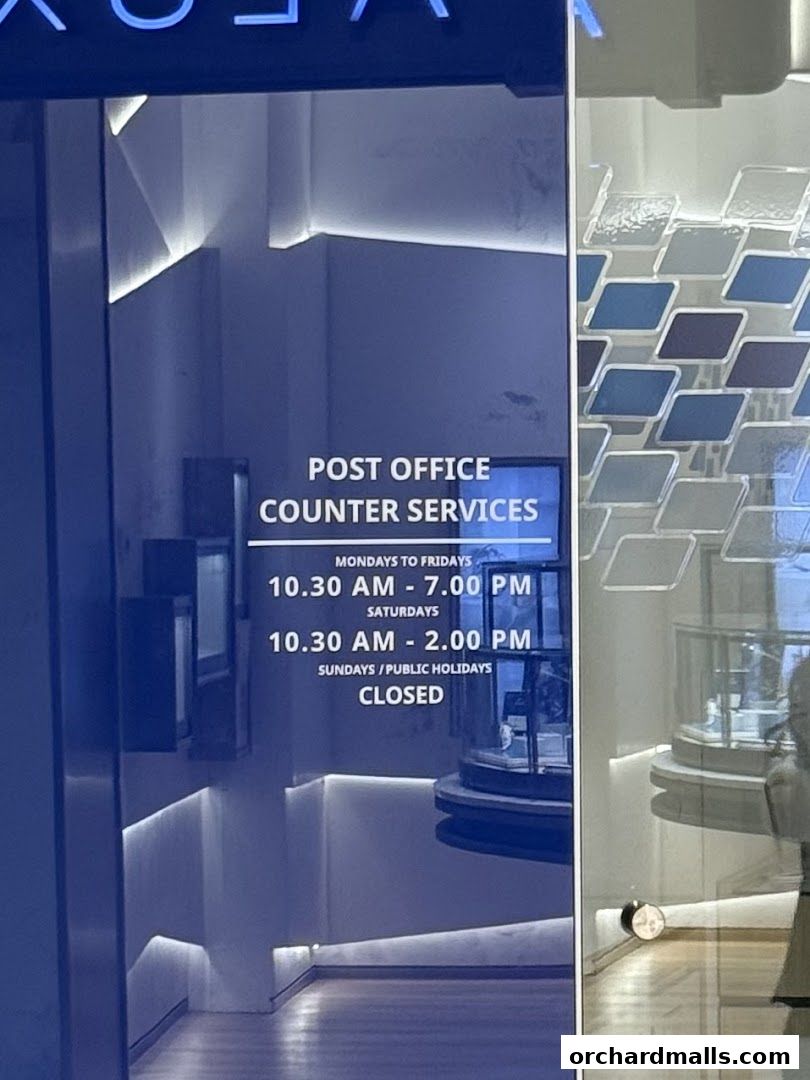 Singapore Post Orchard Branch entrance with operating hours displayed.