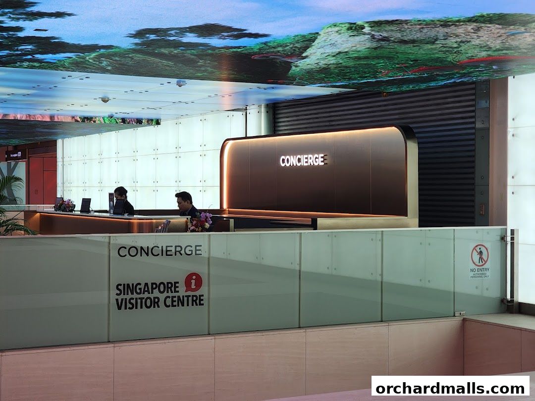 The Singapore Visitor Centre Concierge desk with staff assisting visitors.