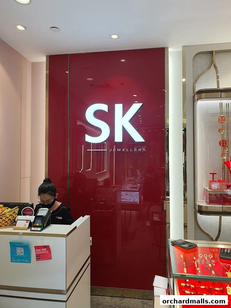 SK Jewellery shop interior with a cashier and display cases filled with jewelry.