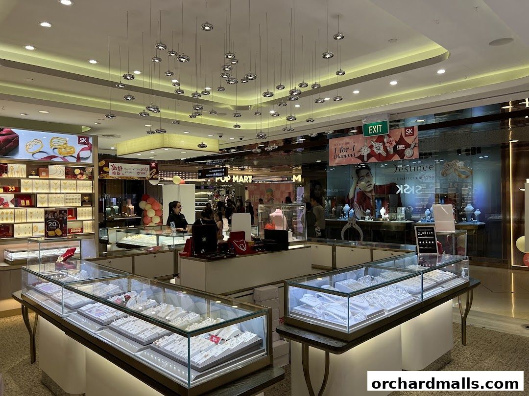 Interior view of a well-lit jewelry store with display cases filled with jewelry and customers browsing.