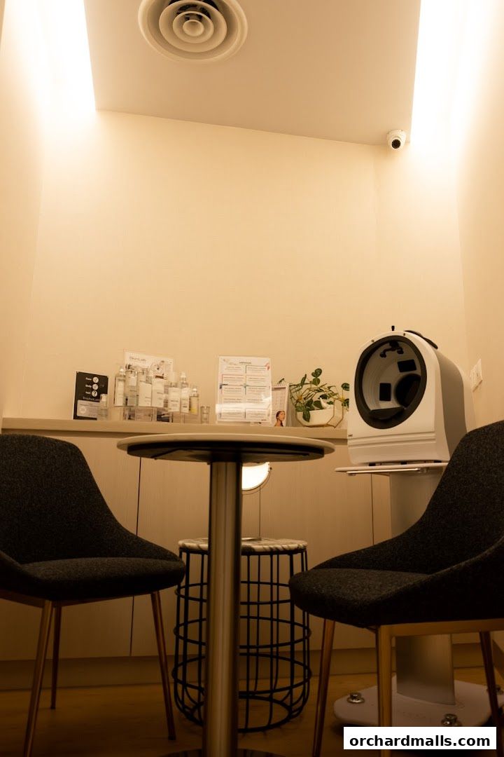 Interior of a medical spa with treatment chairs, a skin analysis machine, and product displays.