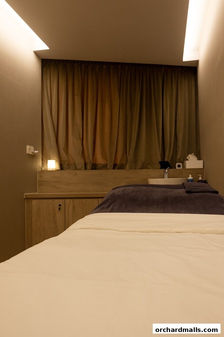 A clean and serene treatment room with a massage bed and sink at SkinLab The Medical Spa.
