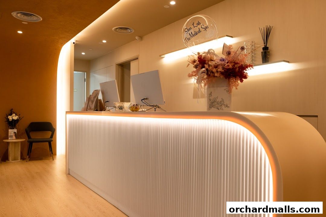The reception area of SkinLab The Medical Spa features a modern, illuminated counter and elegant floral arrangements.